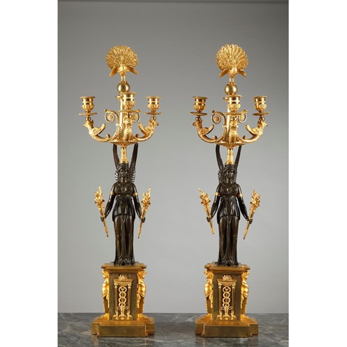 Pair of patinated and gilt bronze three-light candelabra